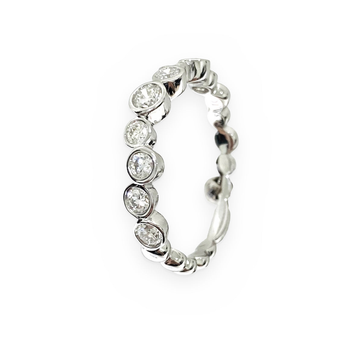 White gold bezel diamond band, angled view