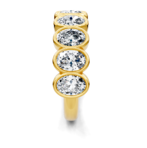 Yellow gold oval diamond bezel band seen from the side