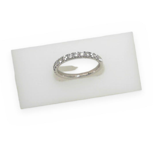 White gold diamond band resting in a frosted display block