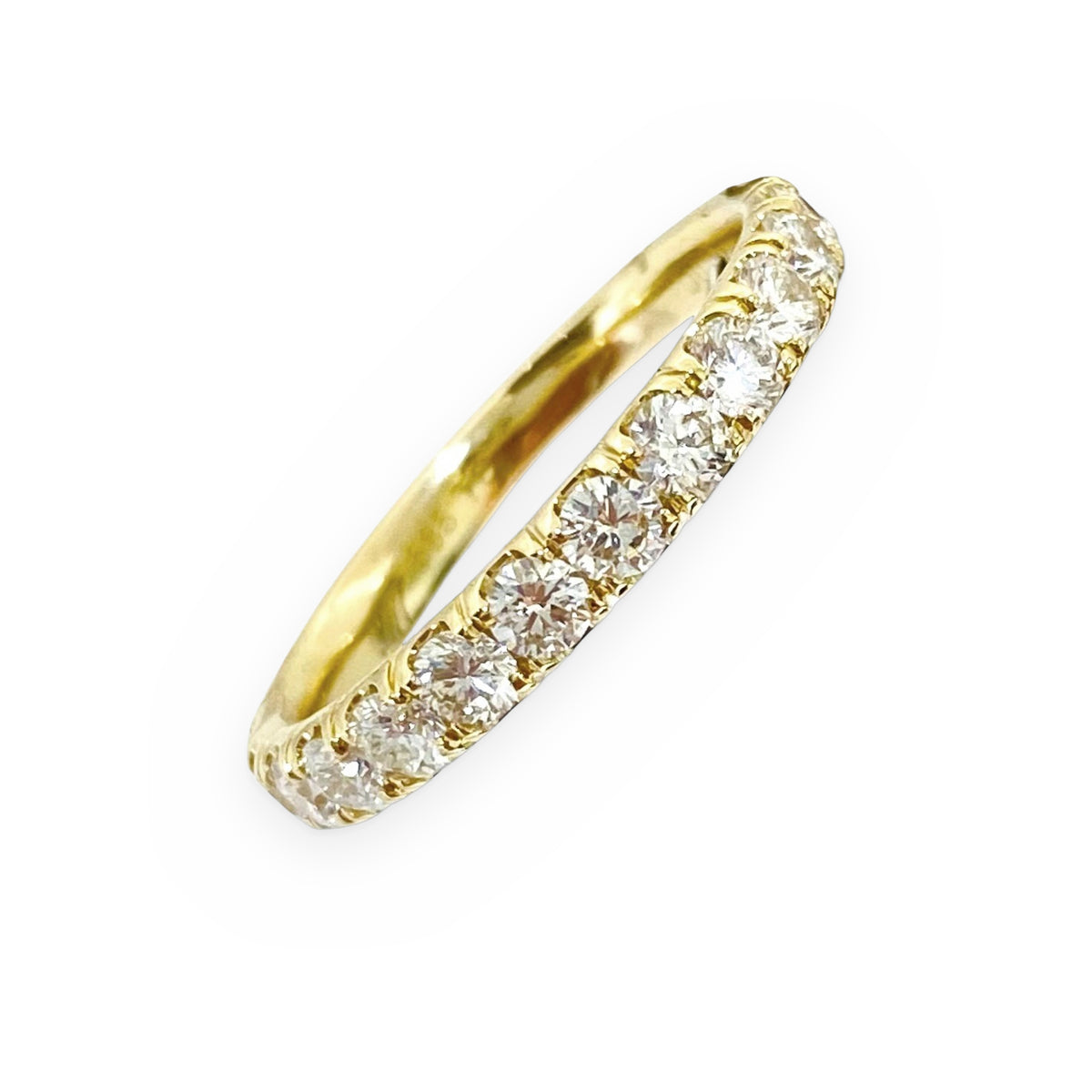 Yellow gold diamond wedding band shown at an angle