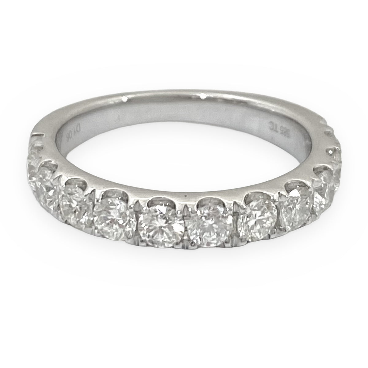 White gold diamond wedding band at an angle with French-set diamonds