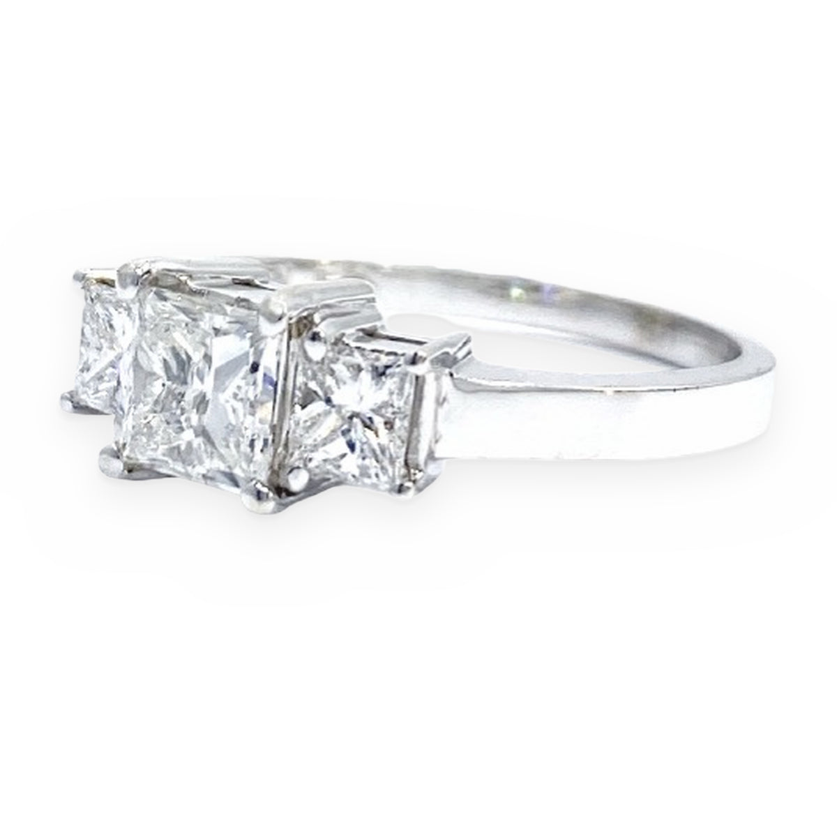 White gold three-stone princess-cut diamond engagement ring, three-quarter angle