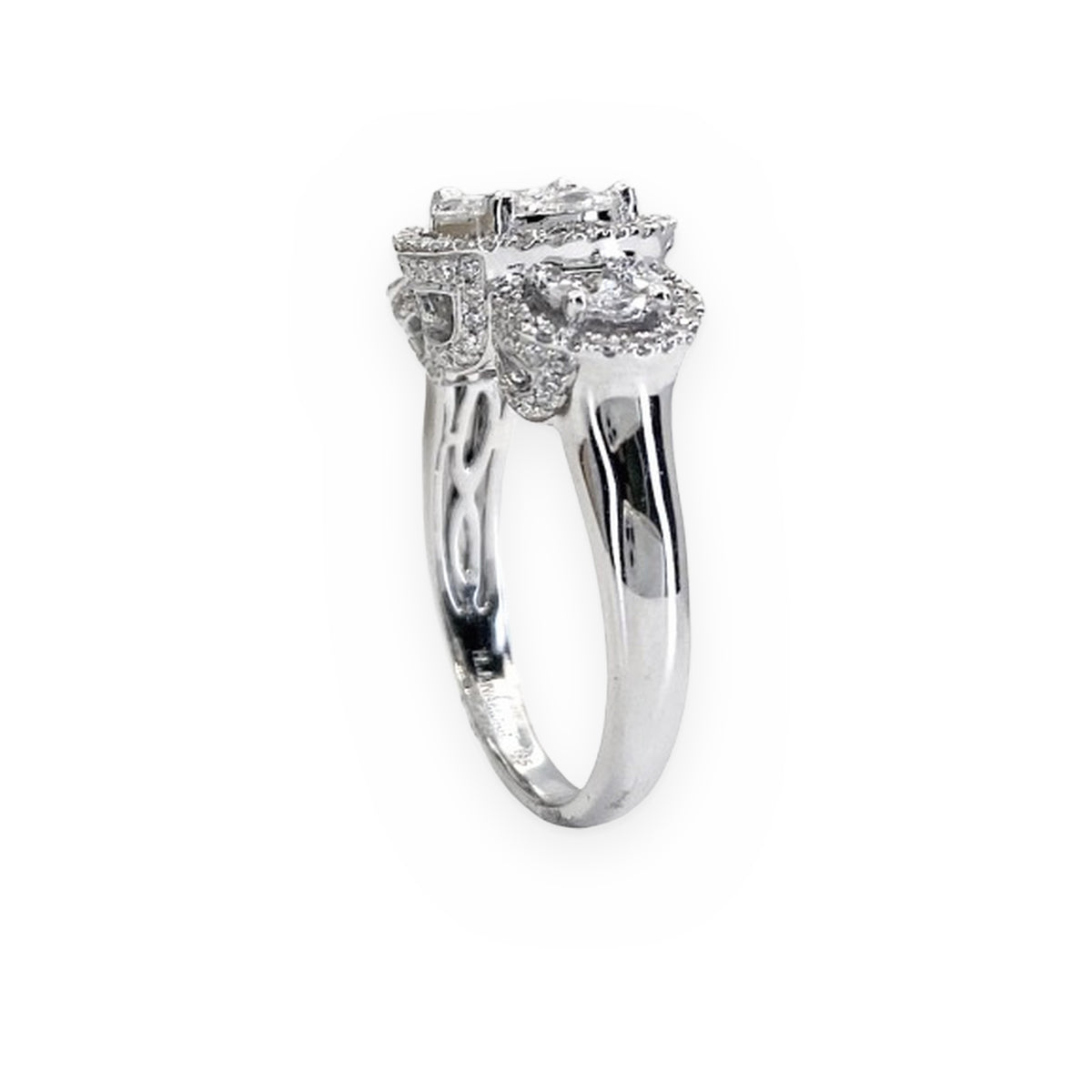 White gold three-stone halo diamond ring, side profile with filigree gallery