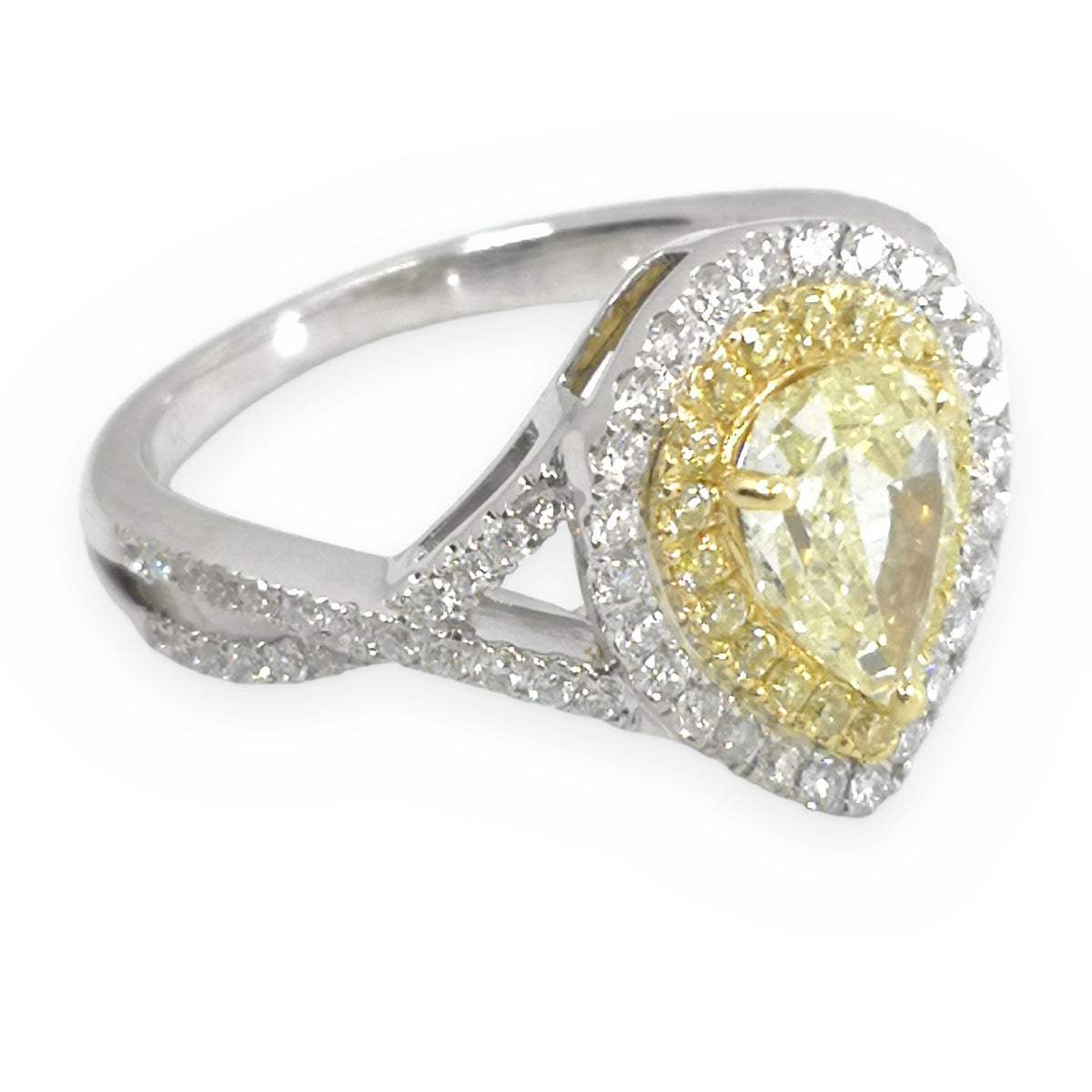 Two-tone gold pear-shaped fancy yellow diamond double halo engagement ring, three-quarter angle