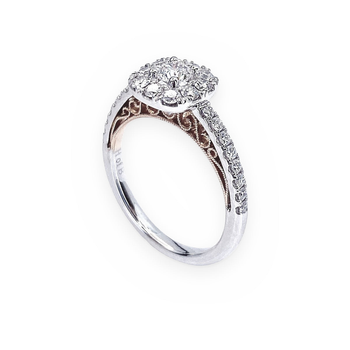 Two-tone gold diamond cluster halo engagement ring with filigree gallery, three-quarter view