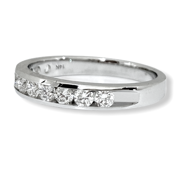 White gold channel-set round diamond wedding band, three-quarter angle