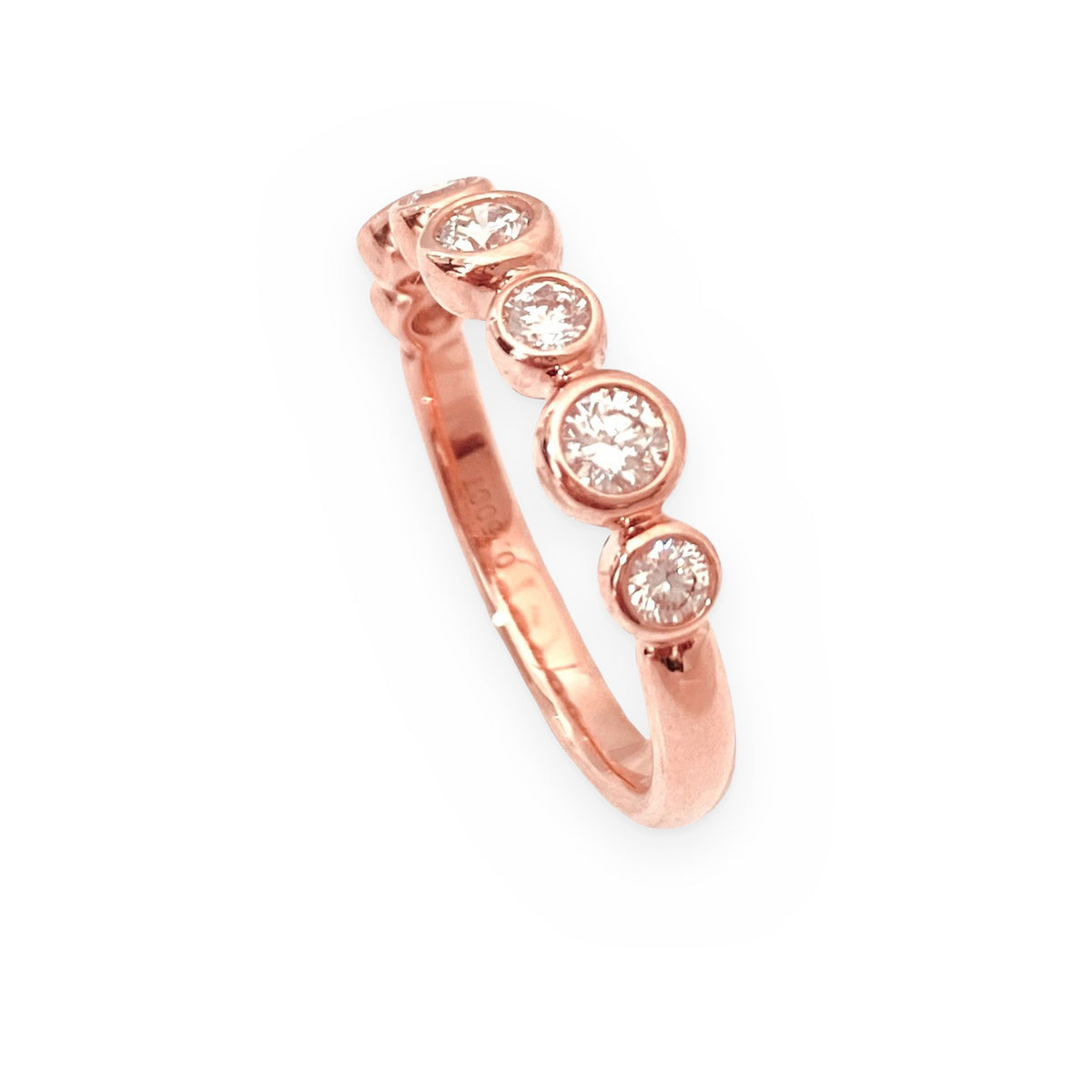Rose gold bezel-set diamond band, angled view