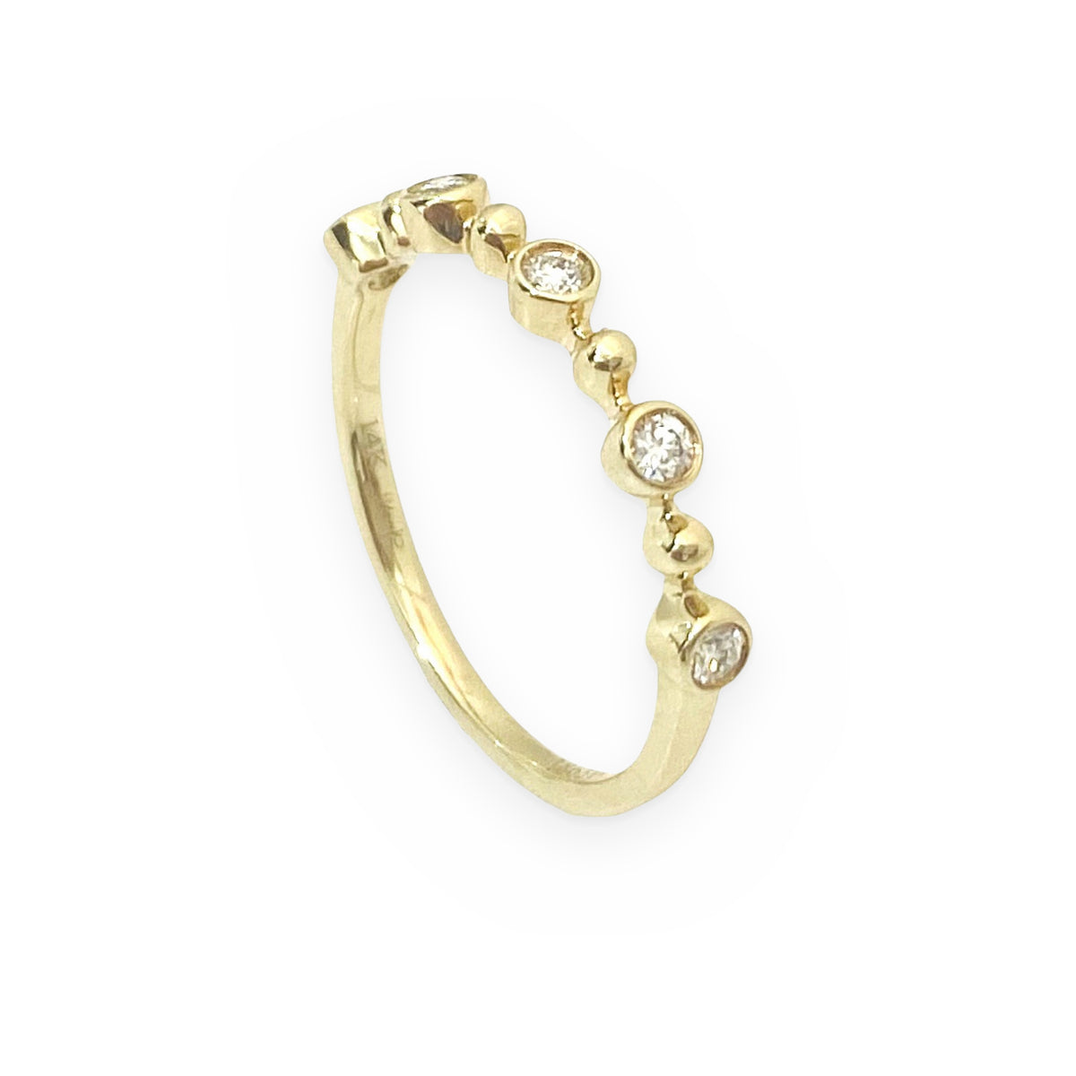 Yellow gold bezel diamond stacking band, angled view