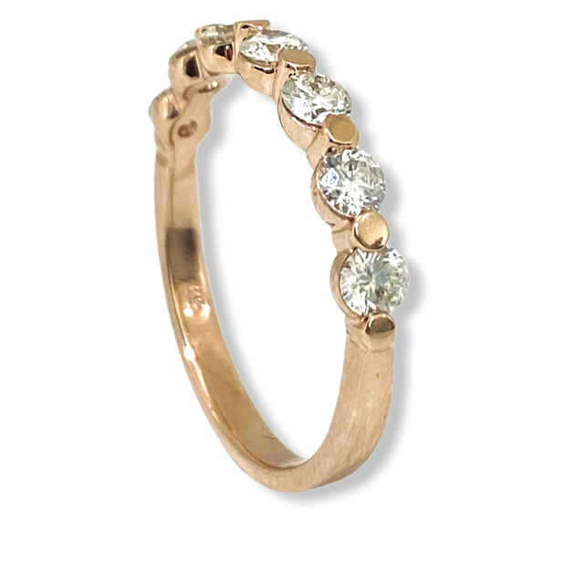 Rose gold shared-prong round diamond band, angled view