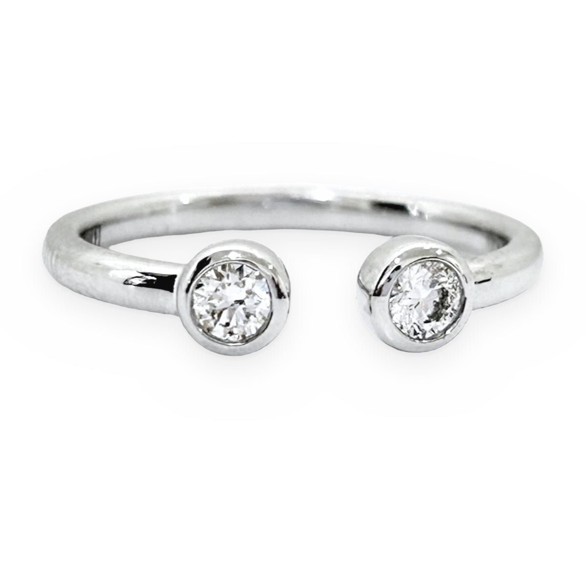 White gold open-cuff ring with two bezel-set round diamonds, front view