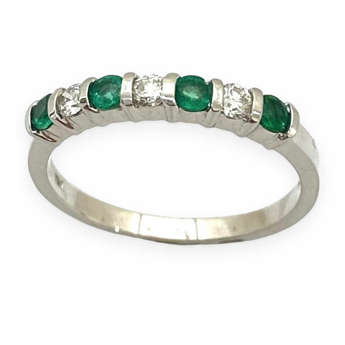 White gold band with alternating emeralds and round diamonds