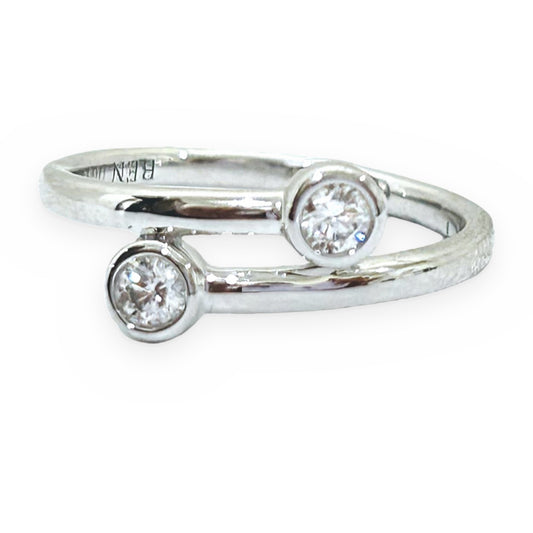 White gold bypass ring with two bezel-set round diamonds