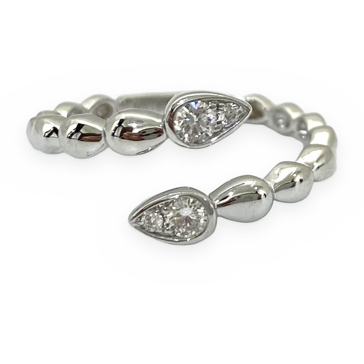 White gold bypass ring with pear-shaped diamond clusters and beaded shank
