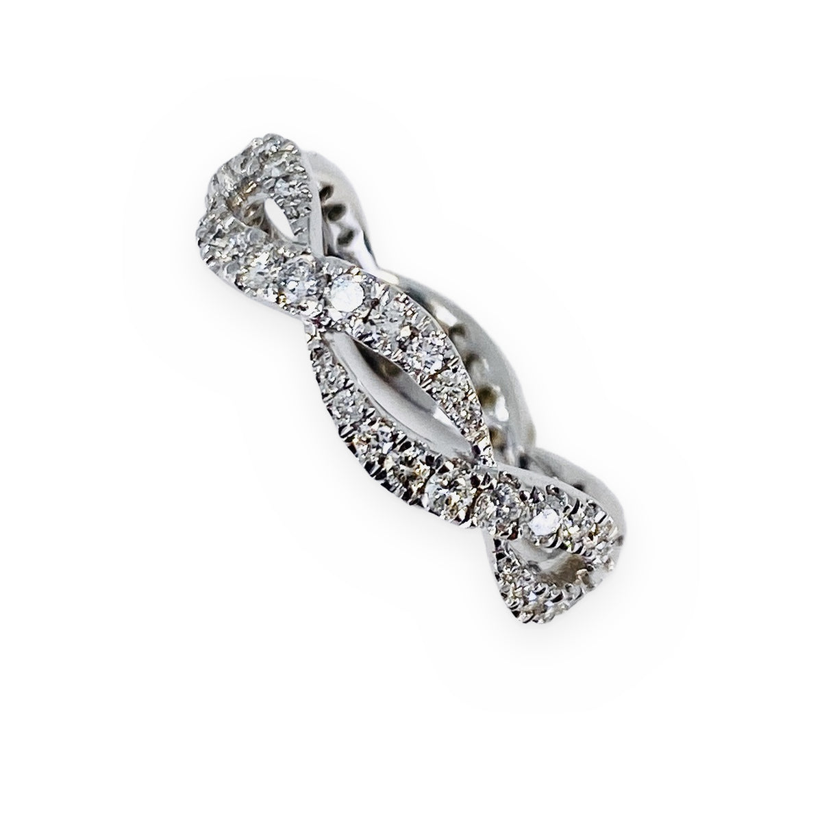 White gold twisted infinity diamond band, top-down angled view