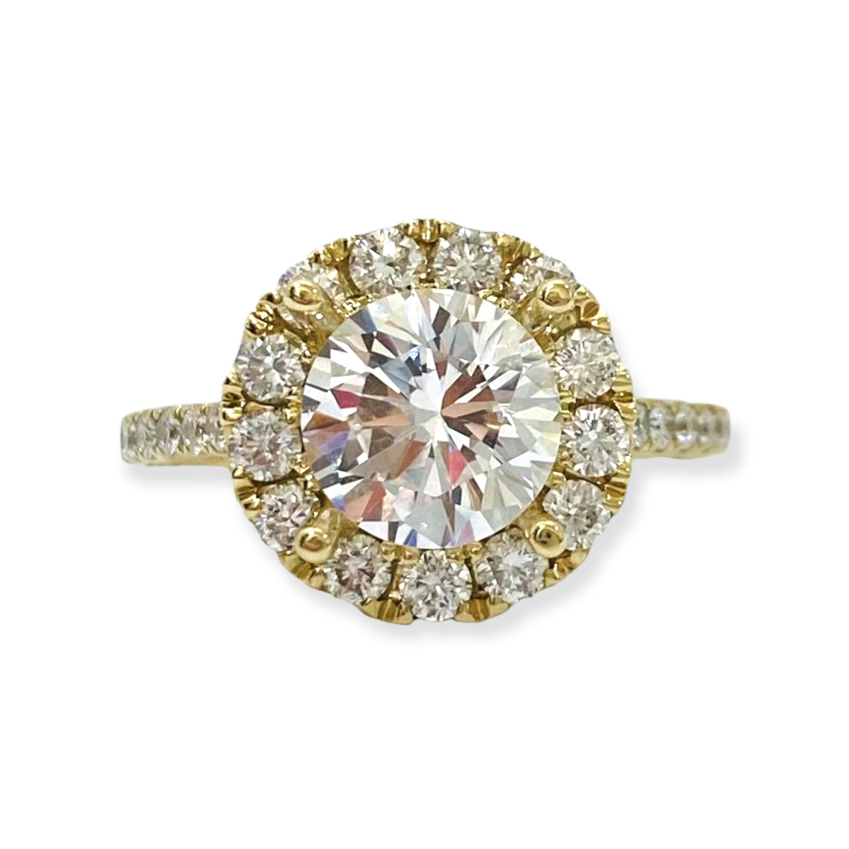 Yellow gold round diamond engagement ring with a diamond halo and pave band