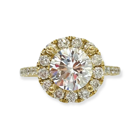 Yellow gold round diamond engagement ring with a diamond halo and pave band
