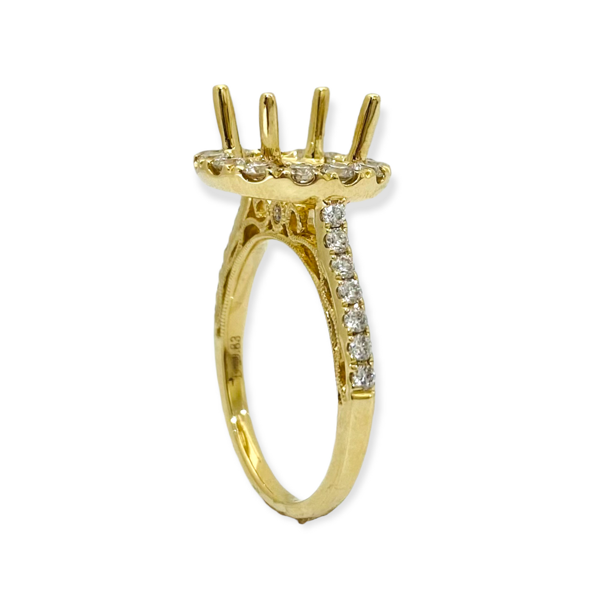 Profile of a yellow gold four-prong diamond halo ring mounting with engraved band