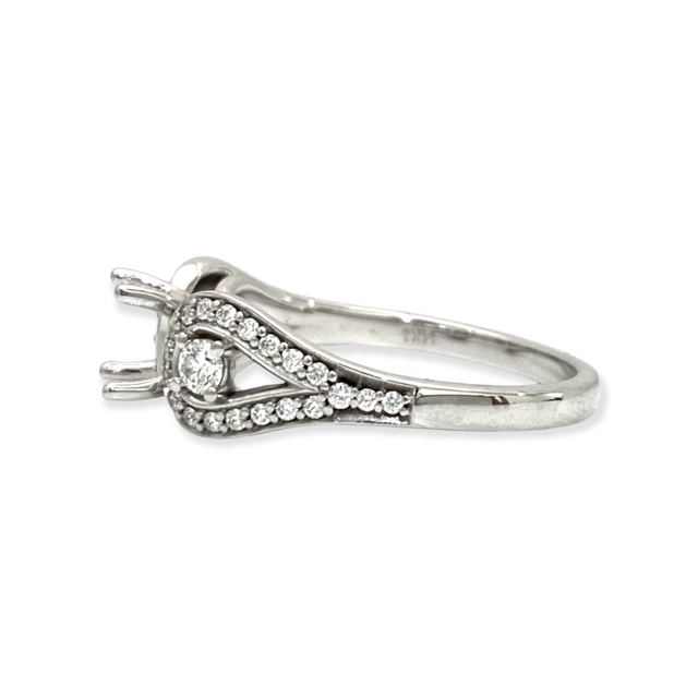 Angled view of a white gold three-stone diamond halo ring semi-mount