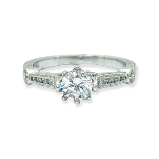 White gold solitaire engagement ring with a round center diamond and engraved band