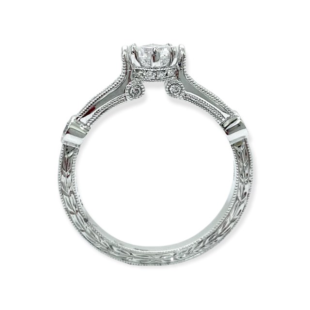 Front profile of a white gold solitaire ring showing the raised round diamond and engraved shank