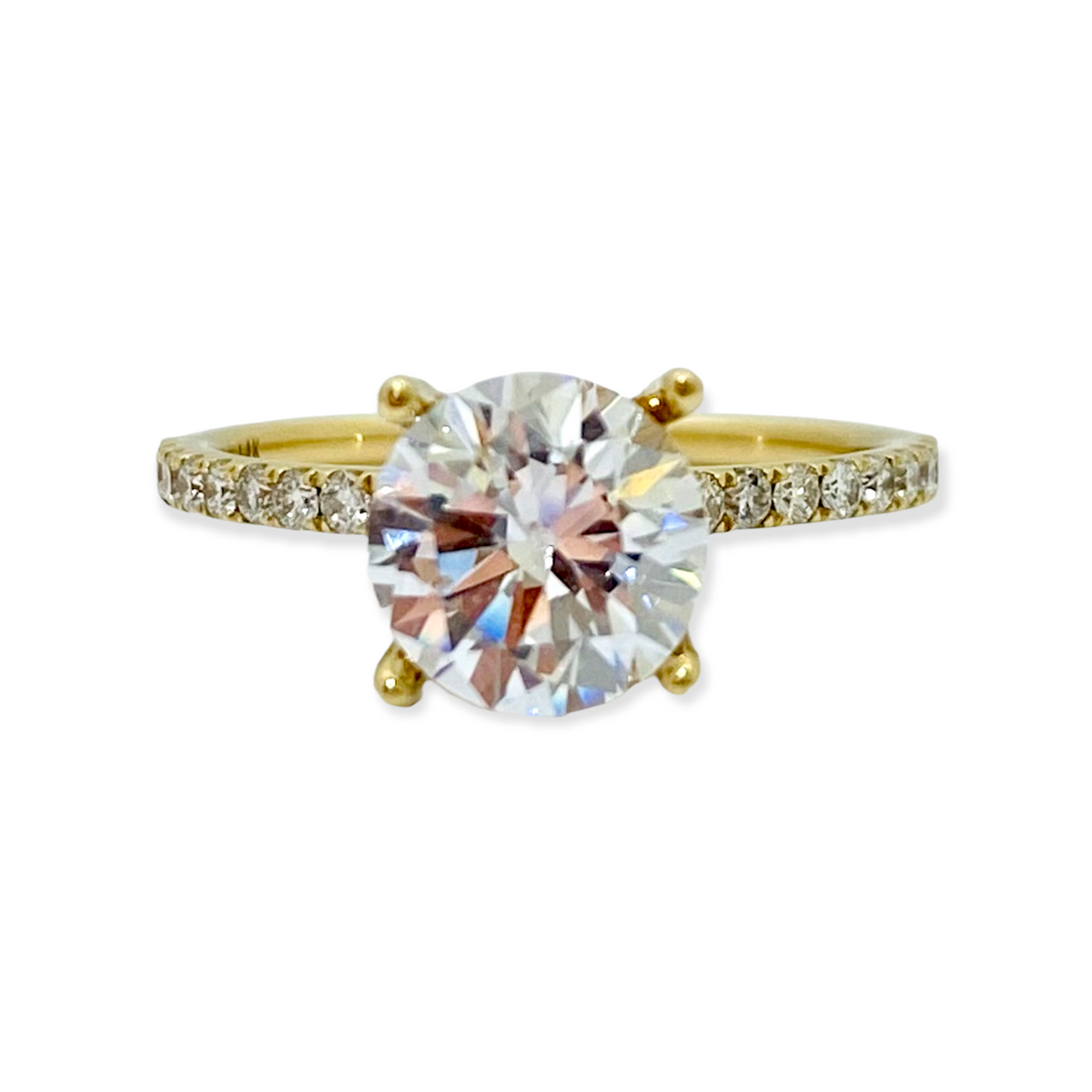 Yellow gold solitaire engagement ring with a round center diamond and pave diamond band