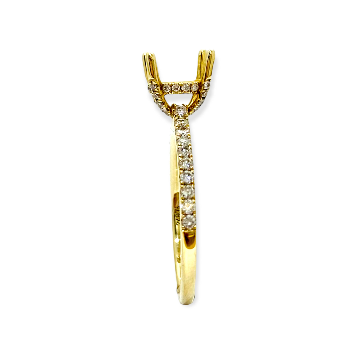 Side view of a yellow gold diamond solitaire ring with a round center stone and pave band