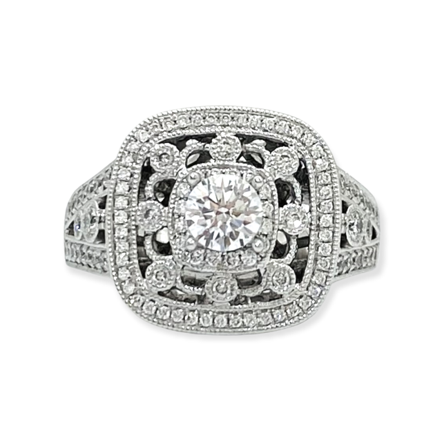 Side view of a white gold vintage-style diamond halo ring with filigree openwork