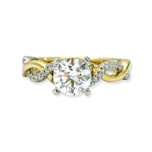 Two-tone yellow and white gold diamond engagement ring with round center stone and twisted infinity band
