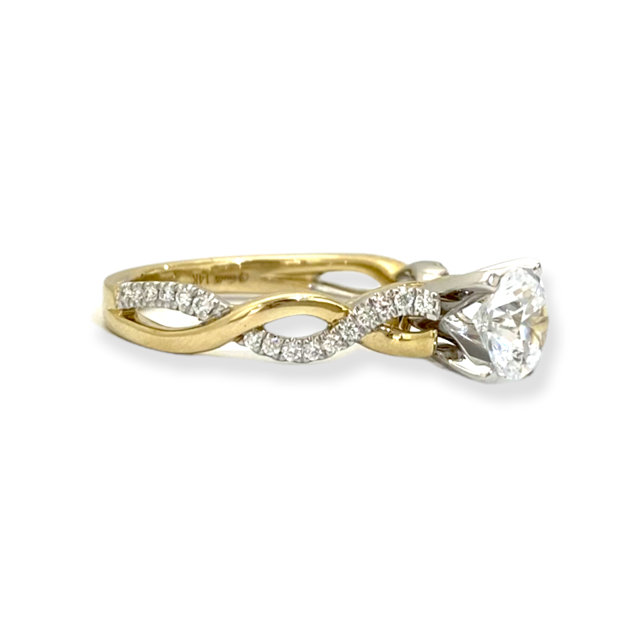 Two-tone yellow and white gold diamond engagement ring with round center and diamond twist shank, side view