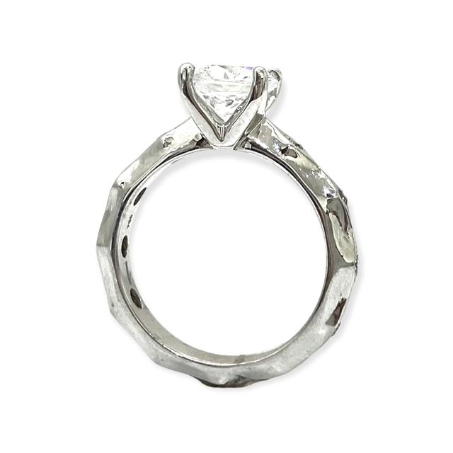 White gold diamond solitaire engagement ring profile view showing round center stone and sculpted band