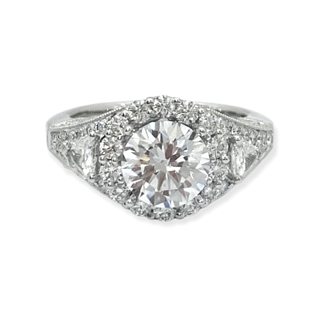 White gold round diamond halo engagement ring with pear side stones and pave shoulders