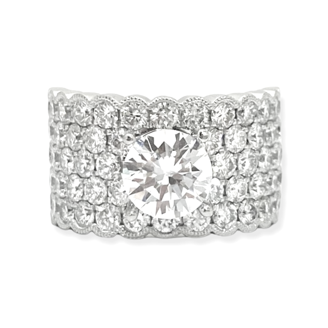 White gold wide diamond band ring with round center stone and multi-row pave scalloped edges