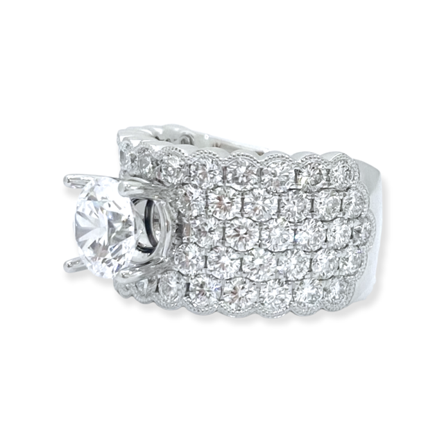 White gold wide multi-row pave diamond ring three-quarter view showing round center stone