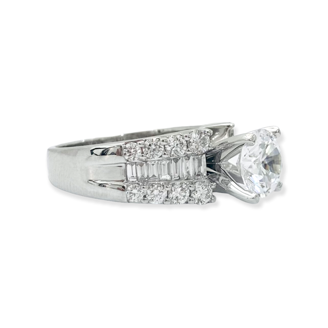White gold round diamond engagement ring side view showing baguette and round diamond shoulders