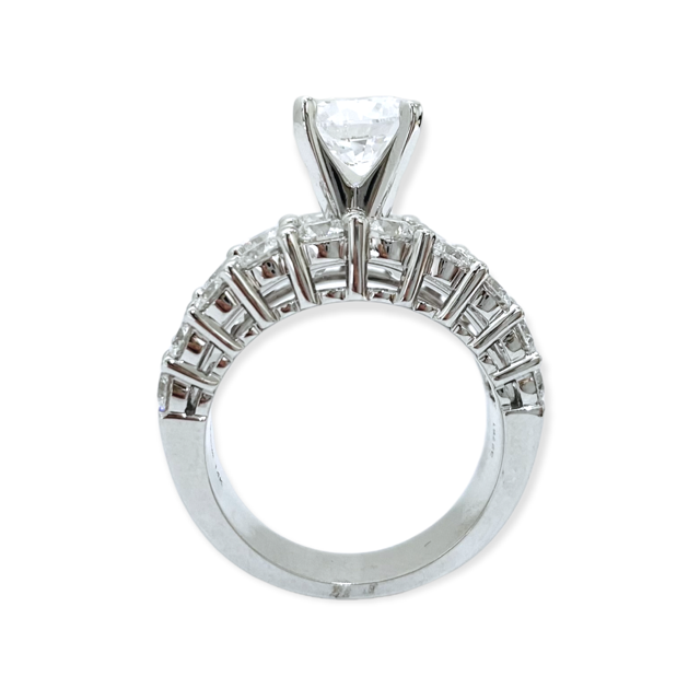 White gold diamond ring viewed head-on showing round center stone and diamond-set shoulders