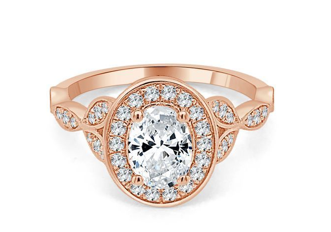 Rose gold oval diamond halo engagement ring with marquise-motif accented shoulders