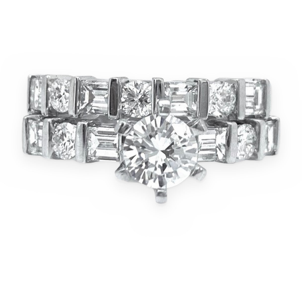 White gold diamond bridal set with round solitaire engagement ring and baguette-and-round diamond wedding band