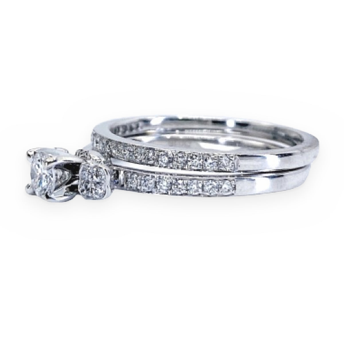 White gold diamond bridal set with solitaire engagement ring and pave band