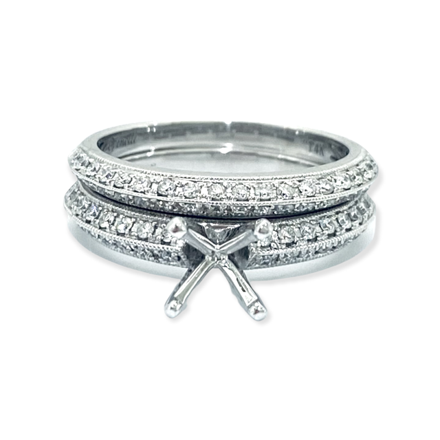 White gold four-prong diamond semi-mount engagement ring with matching band