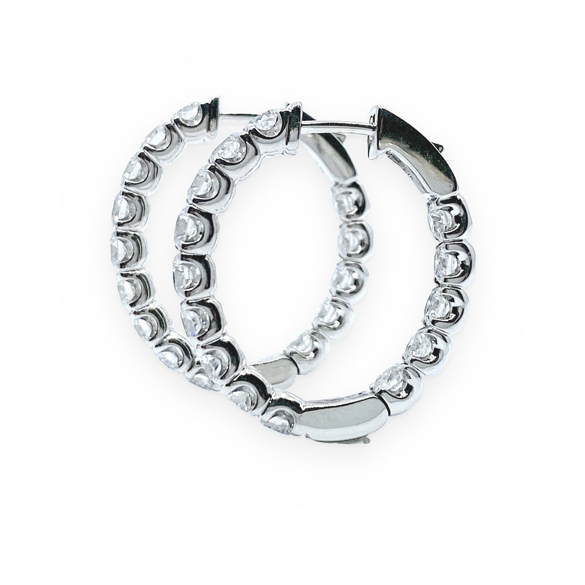 White gold inside-out round diamond hoop earrings in three-quarter view