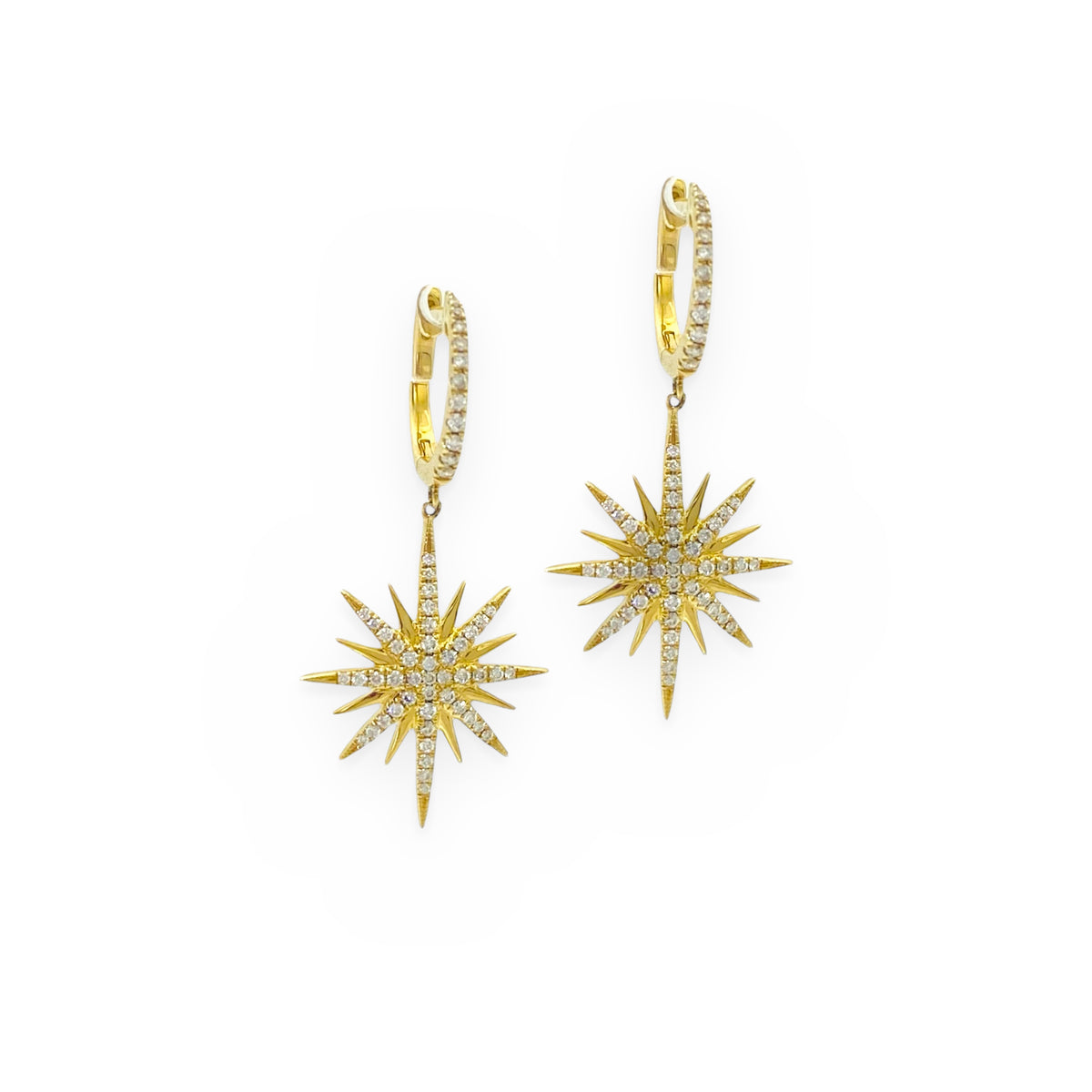 Yellow gold diamond starburst drop earrings on diamond huggies