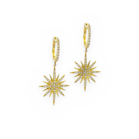 Yellow gold diamond starburst drop earrings on diamond huggies