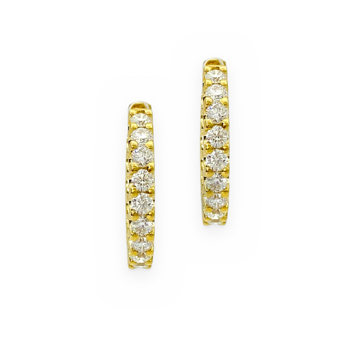 Yellow gold diamond hoop earrings, partial view