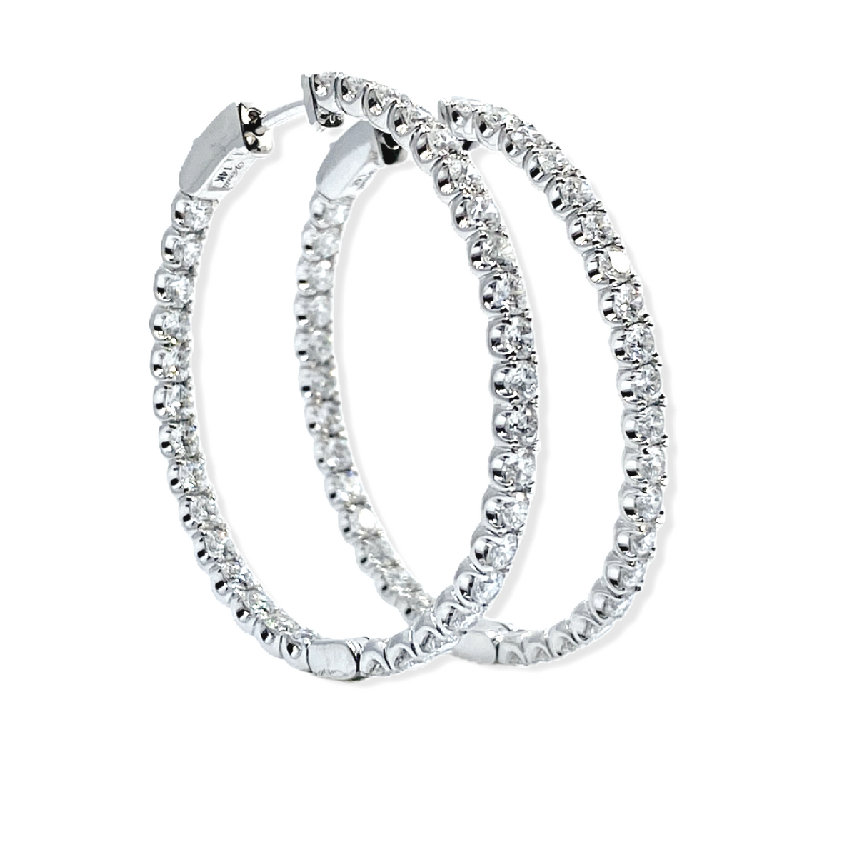 White gold diamond oval hoop earrings, angled view showing 14K stamp