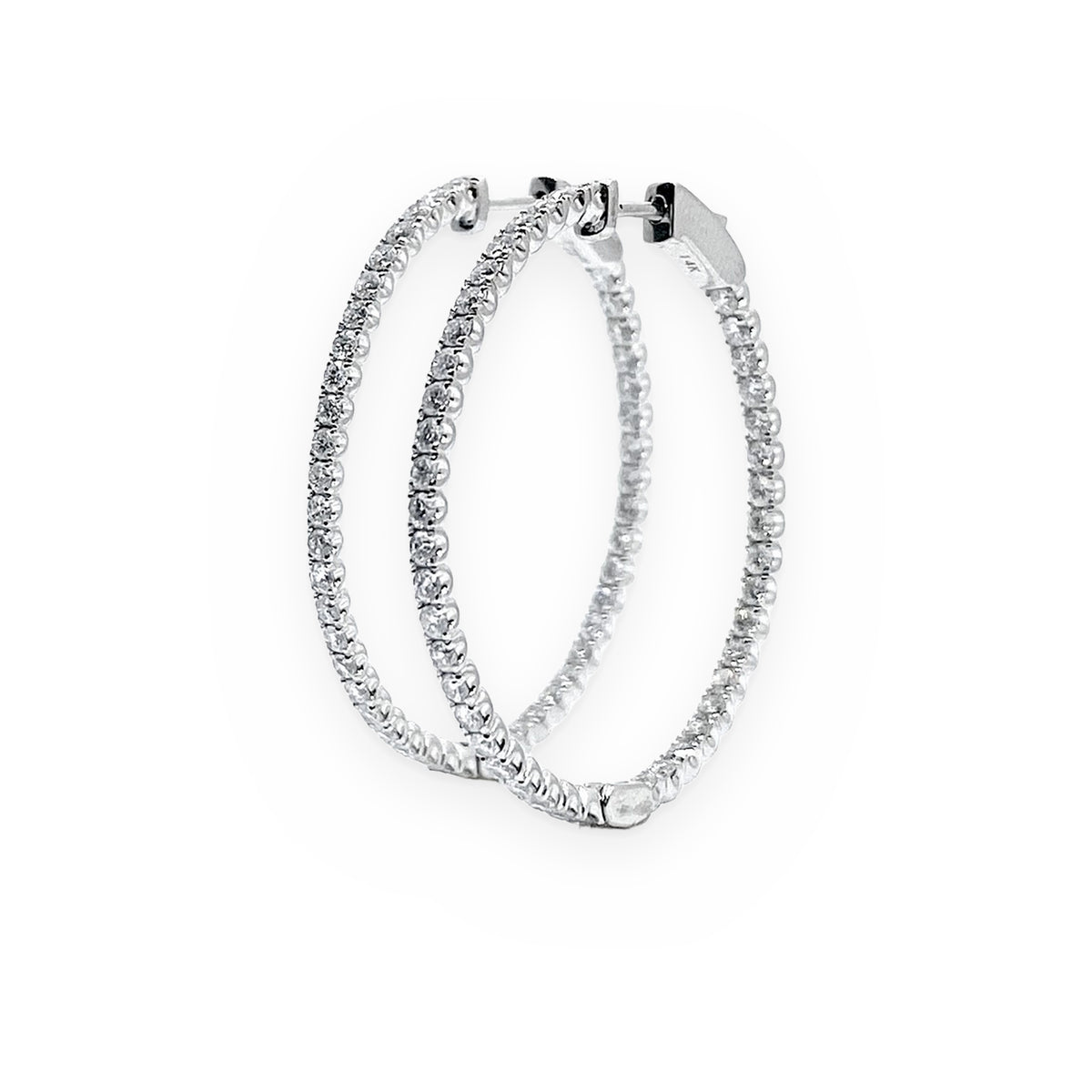 White gold diamond oval hoop earrings, side profile view
