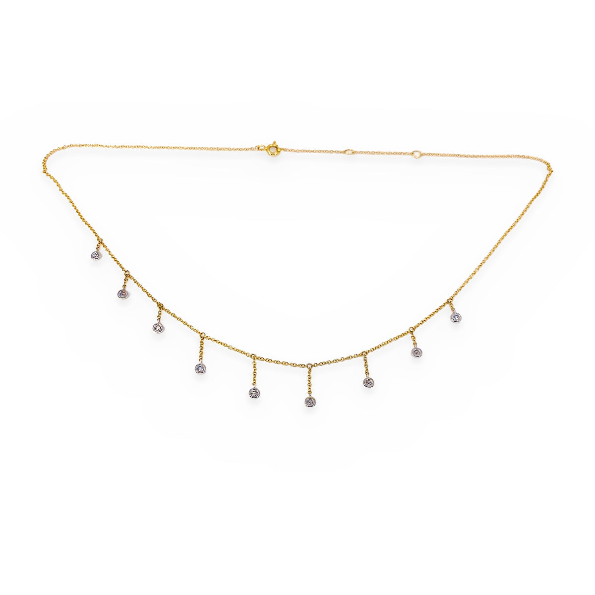 Close-up of a two-tone gold diamond fringe necklace with bezel-set drops
