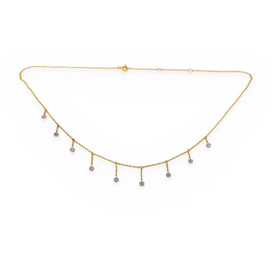 Close-up of a two-tone gold diamond fringe necklace with bezel-set drops