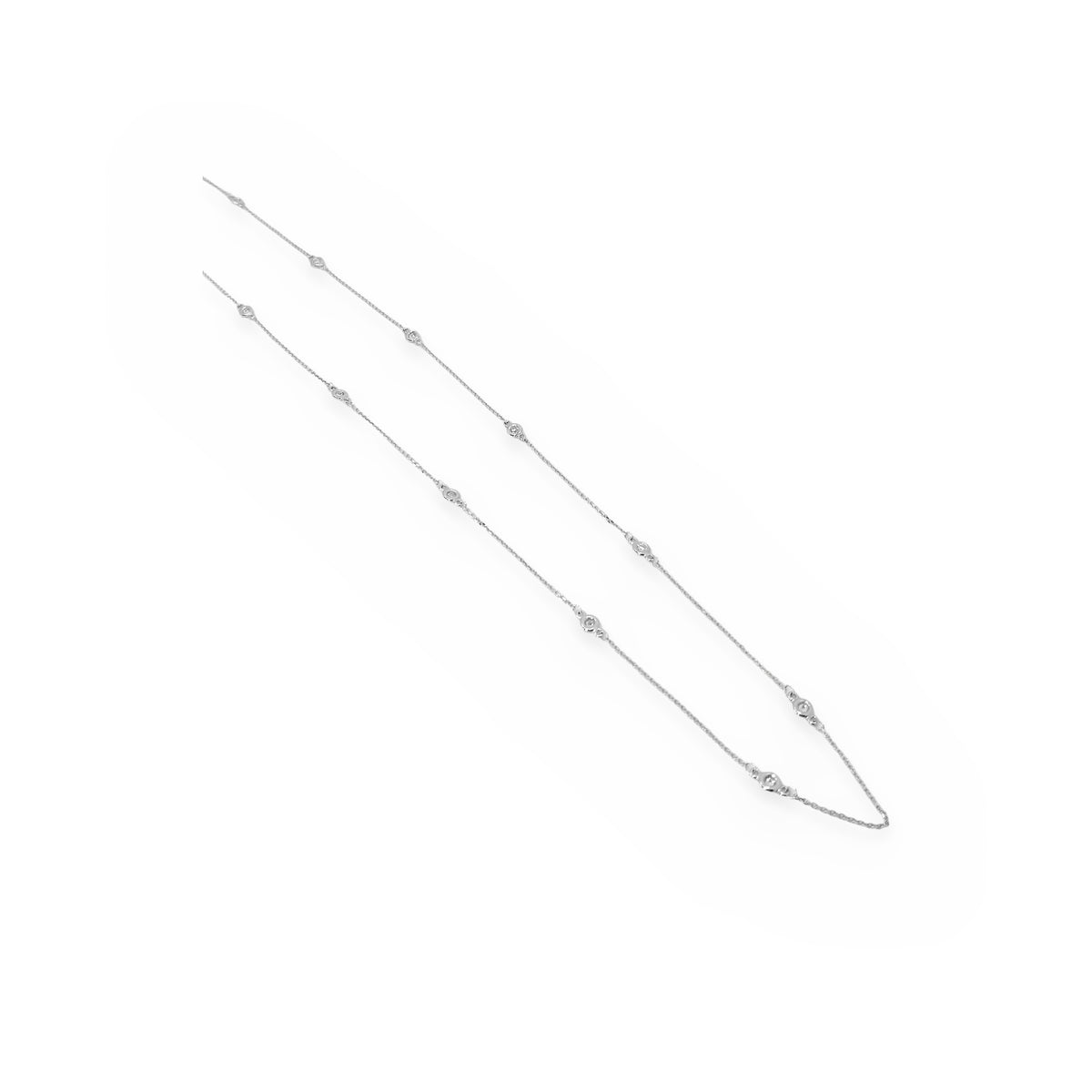 White gold diamonds-by-the-yard station necklace shown at length on white