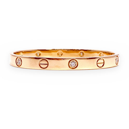 Rose gold Cartier-style love bangle with alternating diamonds and screw motifs
