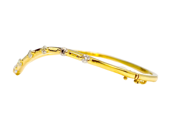 Two-tone gold wave diamond bangle shown from a side angle